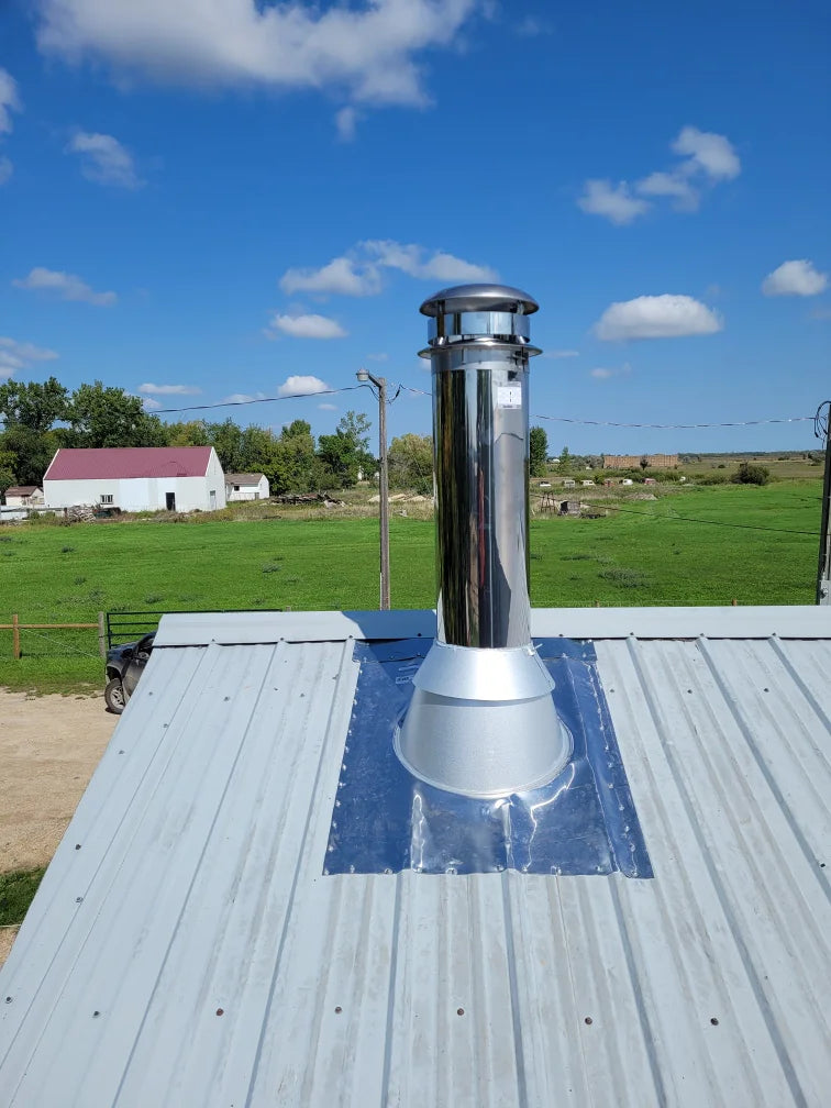 Stainless chimney through a metal roof, installed by Backwoods