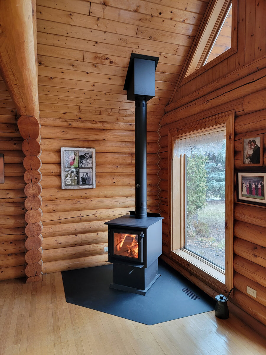 Wood stove installed in a log home by Backwoods