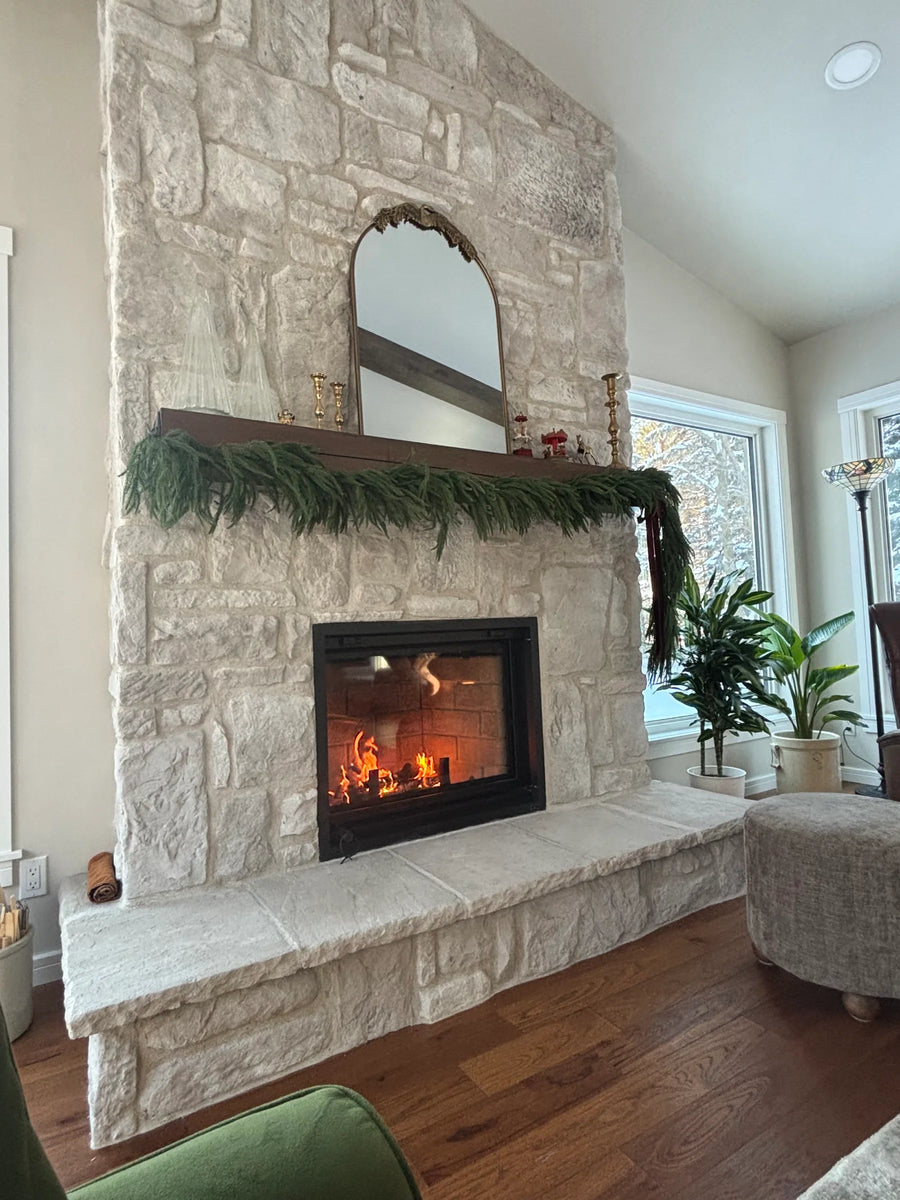 White stone wood fireplace with mantel, installed by Backwoods